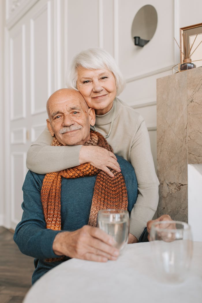 Crafting Captivating Headlines: Your awesome post title goes here Elderly couple enjoying a warm and loving moment indoors, drinking together.